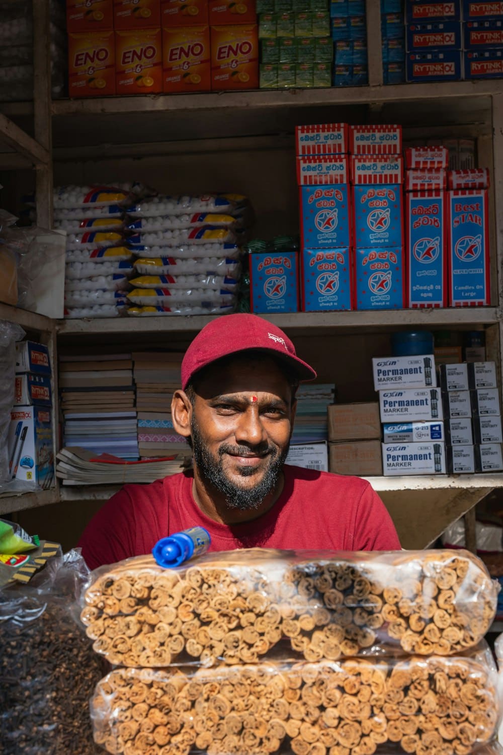 A small shop owner behind the counter of his store